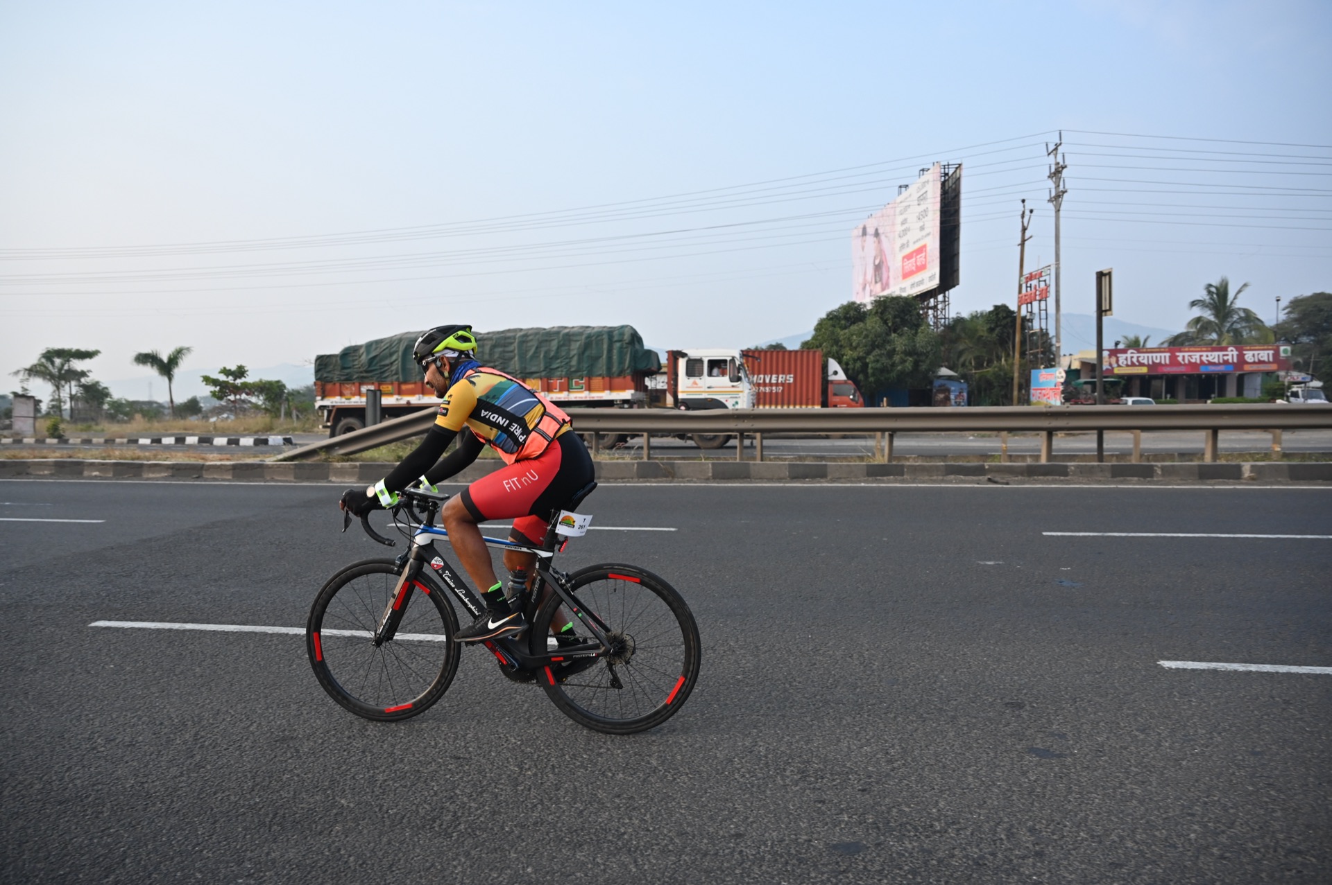 Sudhakar Reddy Gade cycling alone on a highway at dawn