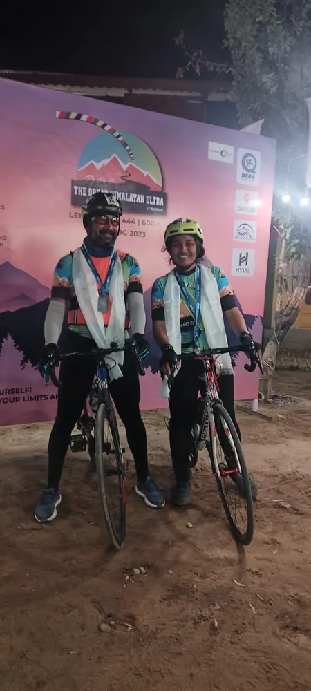 Sudhakar and Niharika with their bicycles at night before the Great Himalayan Ultra backdrop
