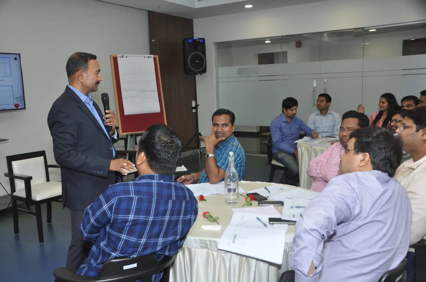 Sudhakar facilitating a table of participants in a workshop